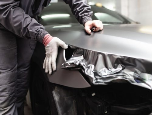 inspecting damaged car